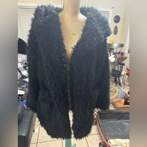 New with tags black fuzzy sweater with hood size L. Super soft.
